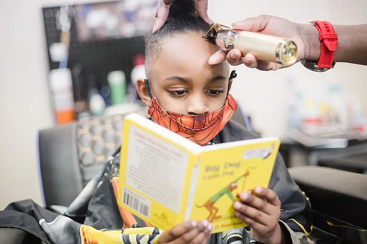 Photograph of a child getting a haircut